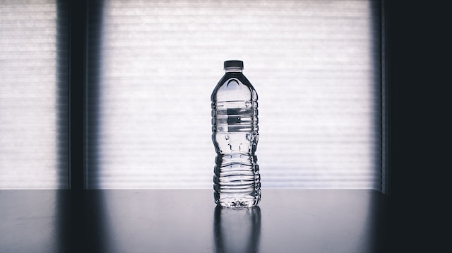 Plastic water bottle in window sill. 