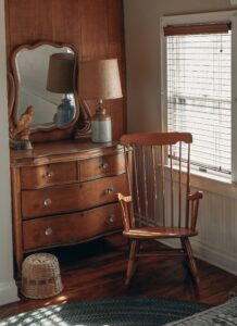 how to polish wood furniture - a photo of a wooden vanity with mirror and a chair