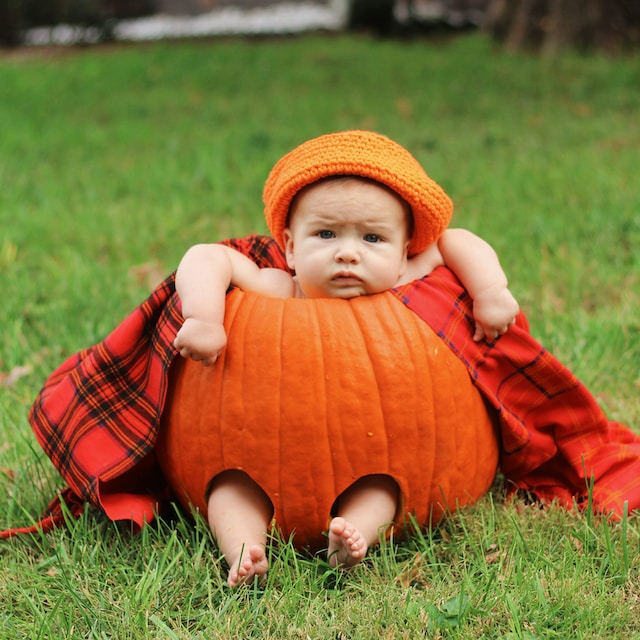 pumpkin carving ideas - a baby dressing a carved pumpkin