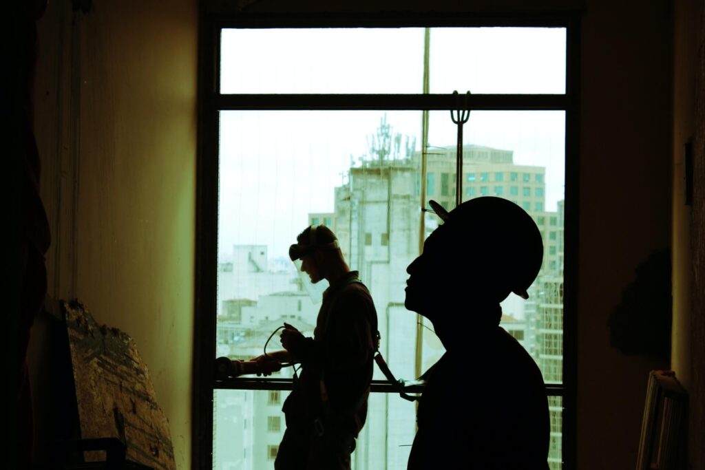 Silhouettes of two construction workers