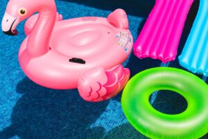 Pool floor with flamingo, donut and bed floats