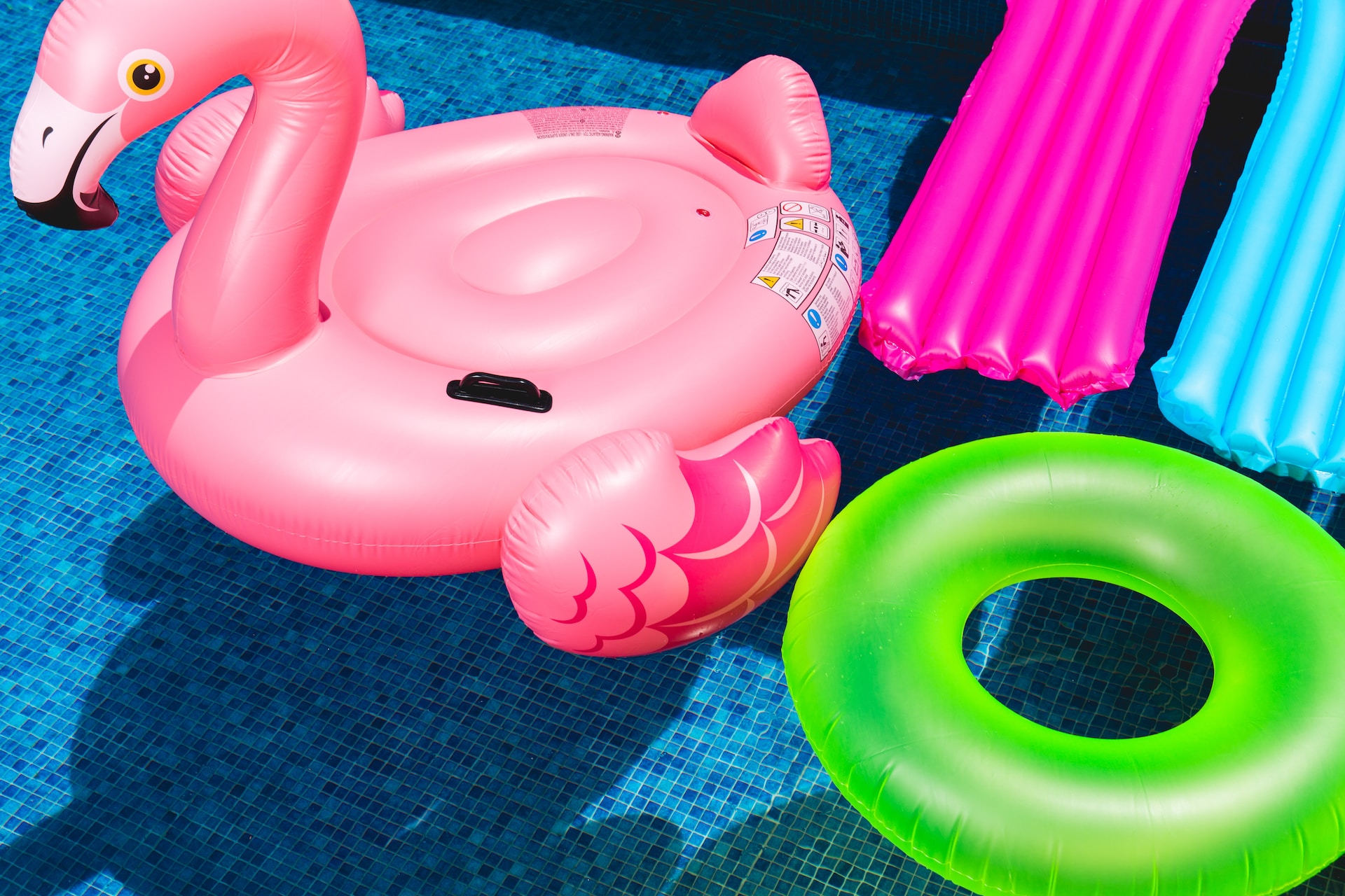 Pool floor with flamingo, donut and bed floats