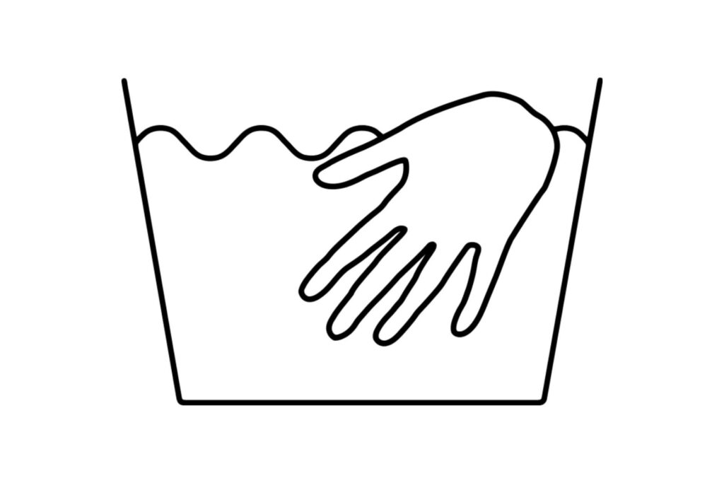 A hand reaching into a washtub