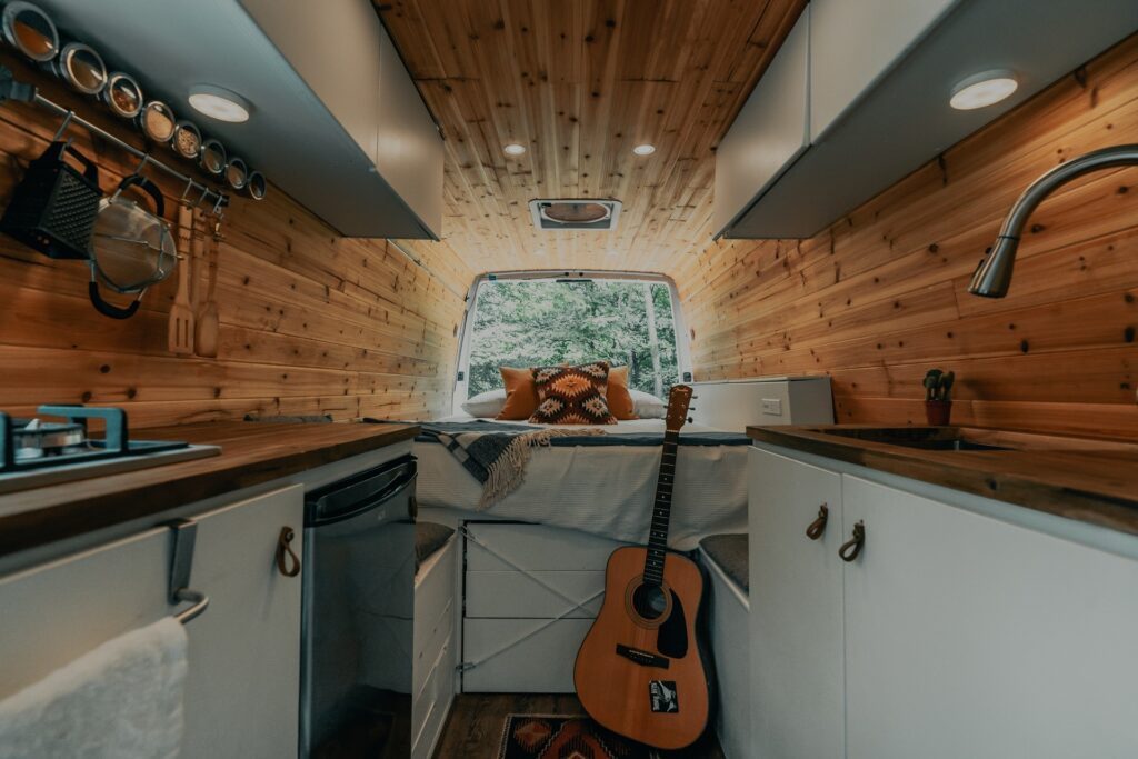 Interior of an RV showing a raised bed with storage underneath.