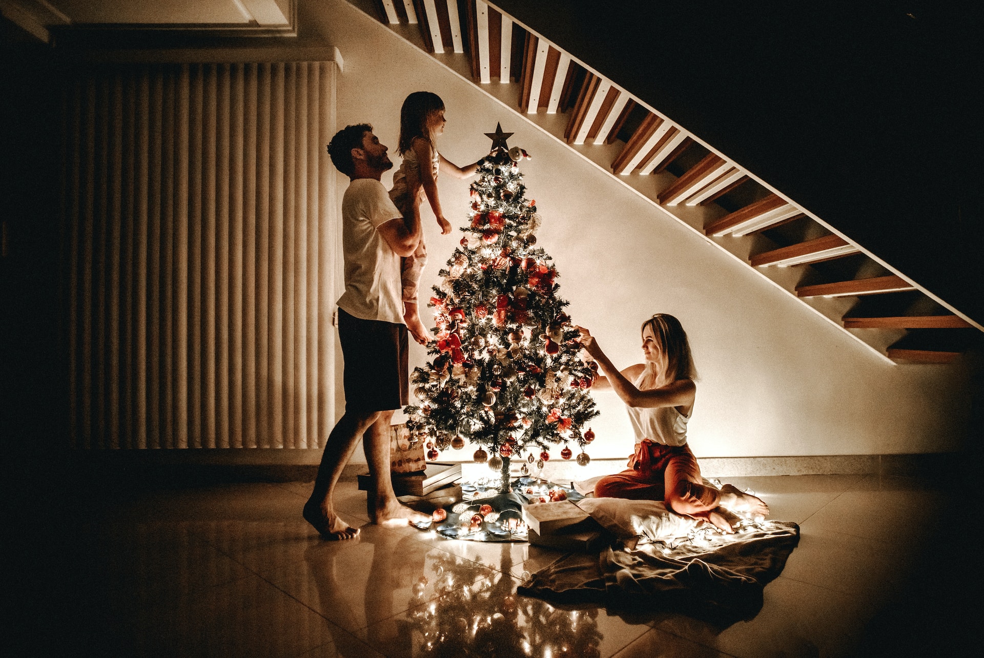 Family decorating Christmas tree.