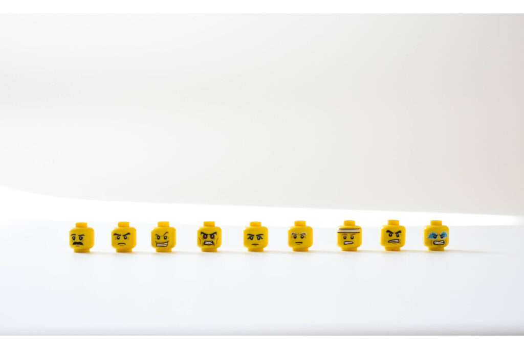 LEGO minifigure heads showing various emotions.