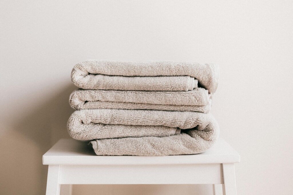 gray stacked towels on a white table