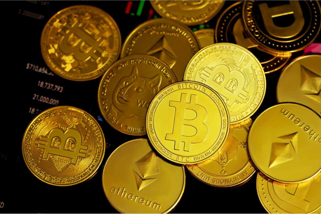Gold coins with different cryptocurrency logos.