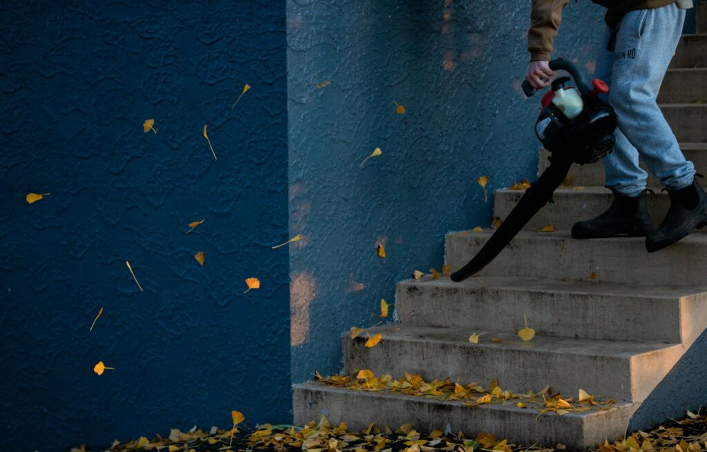 man using a leaf blower on stairs