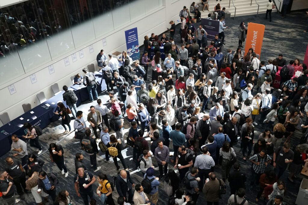 Crowd of people networking at a conference.