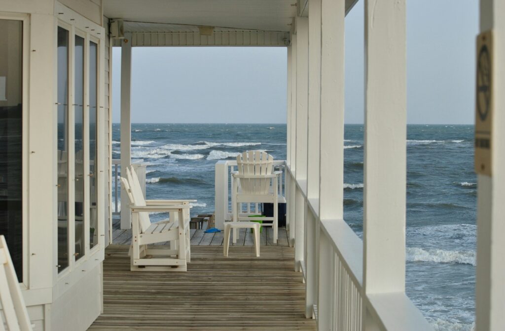 White Wooden Chair on Wooden Balcony by Beach