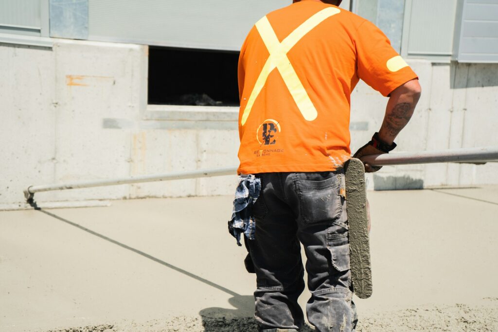 A person smoothing concrete.