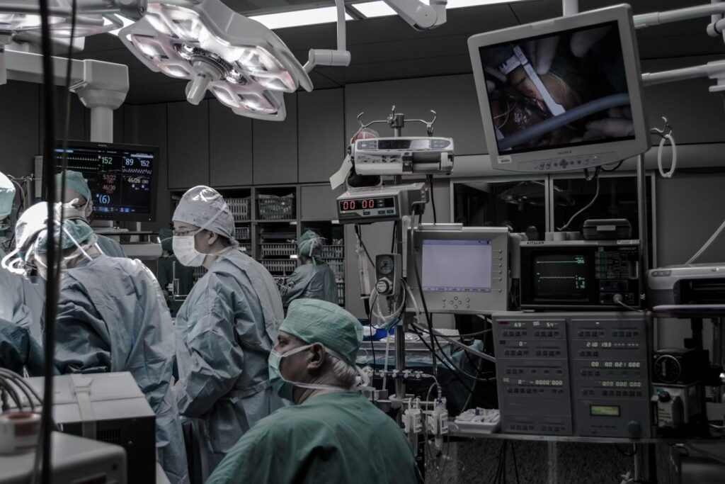 masked people in surgical scrubs