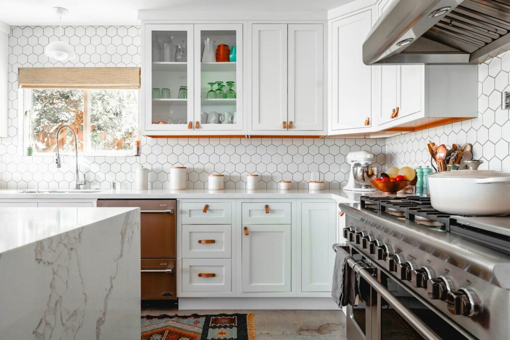 White kitchen with backsplash tile and an island