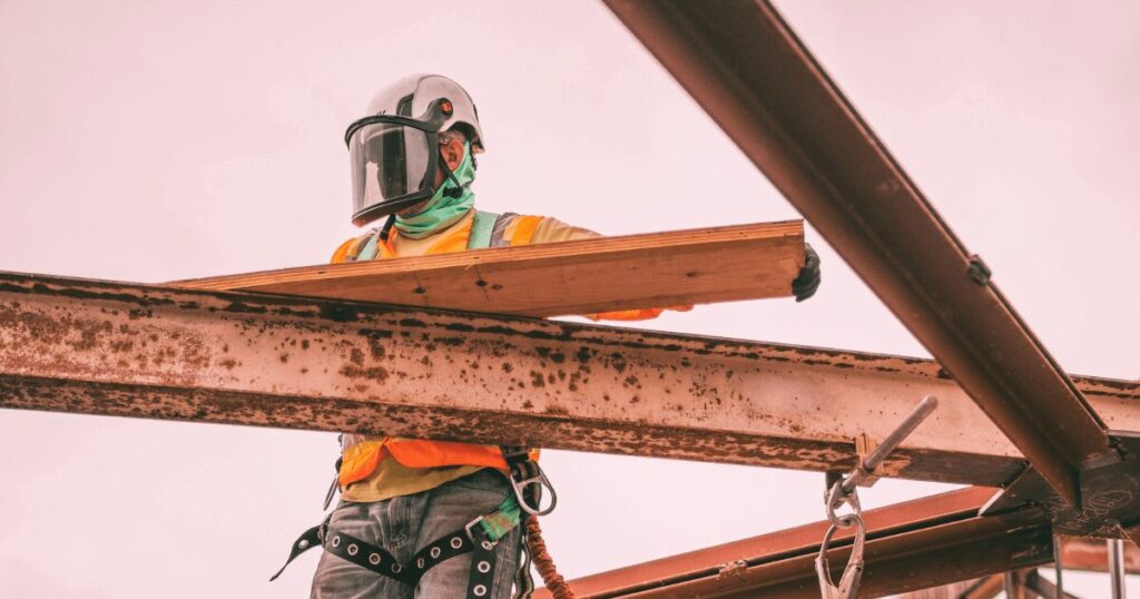 Construction worker busy deconstructing an old building