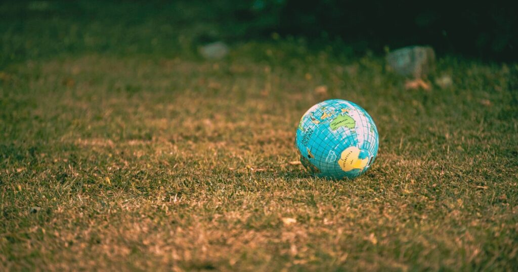 Earth globe ball on green grass