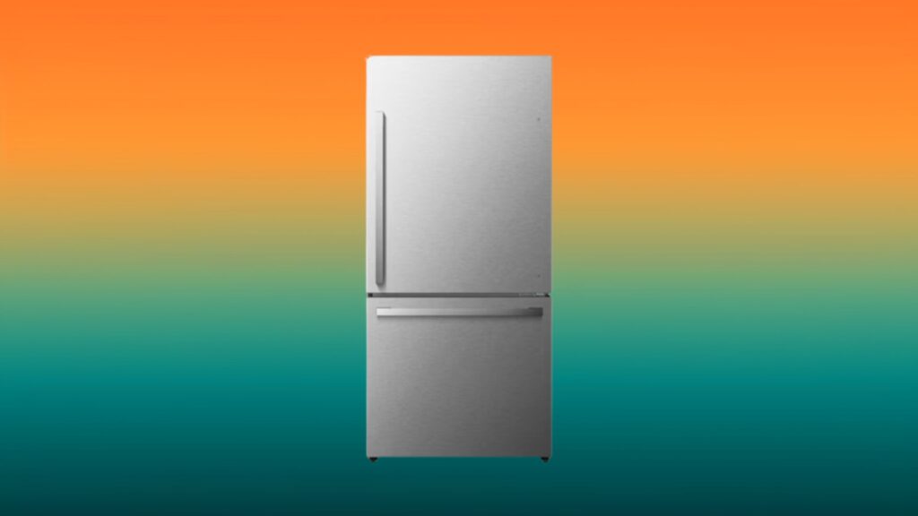 silver fridge with bottom freezer in front of an orange and teal gradient background