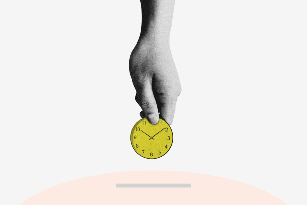 A hand putting a clock in the shape of a coin in a piggy bank