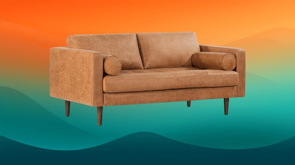 tan leather sofa in front of an orange and teal background