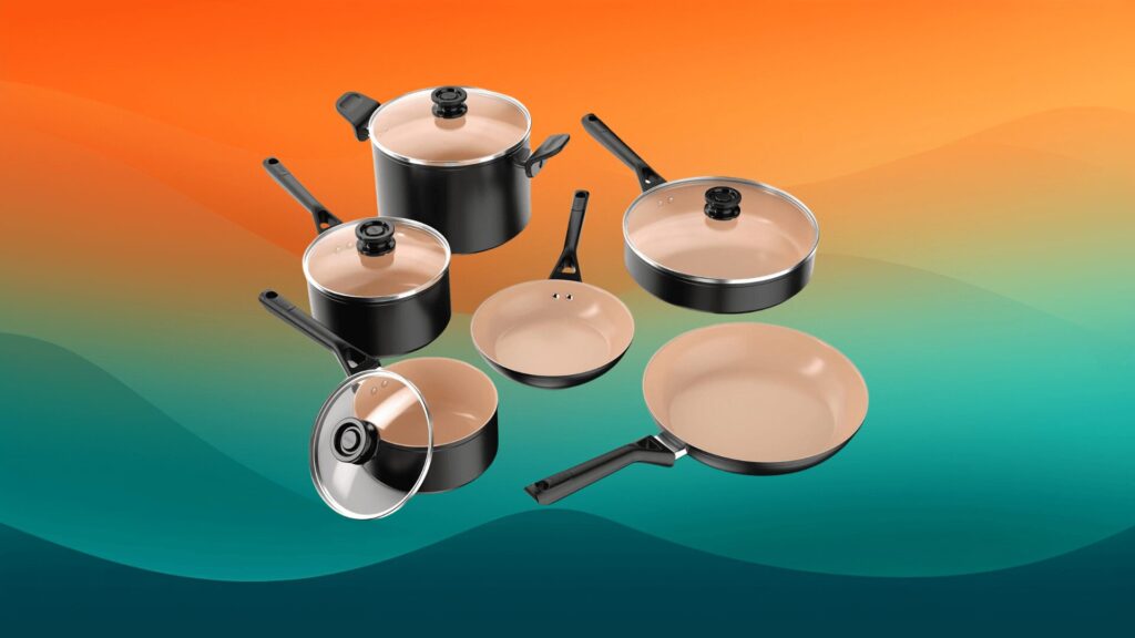 set of black pots and pans with lids in front of an orange and teal background