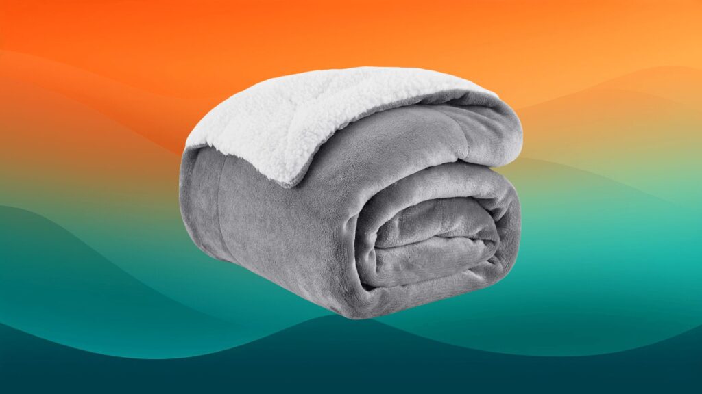 gray and sherpa throw blanket in front of an orange and teal background