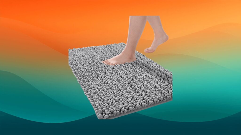 feet stepping on a plush gray bath rug in front of an orange and teal background