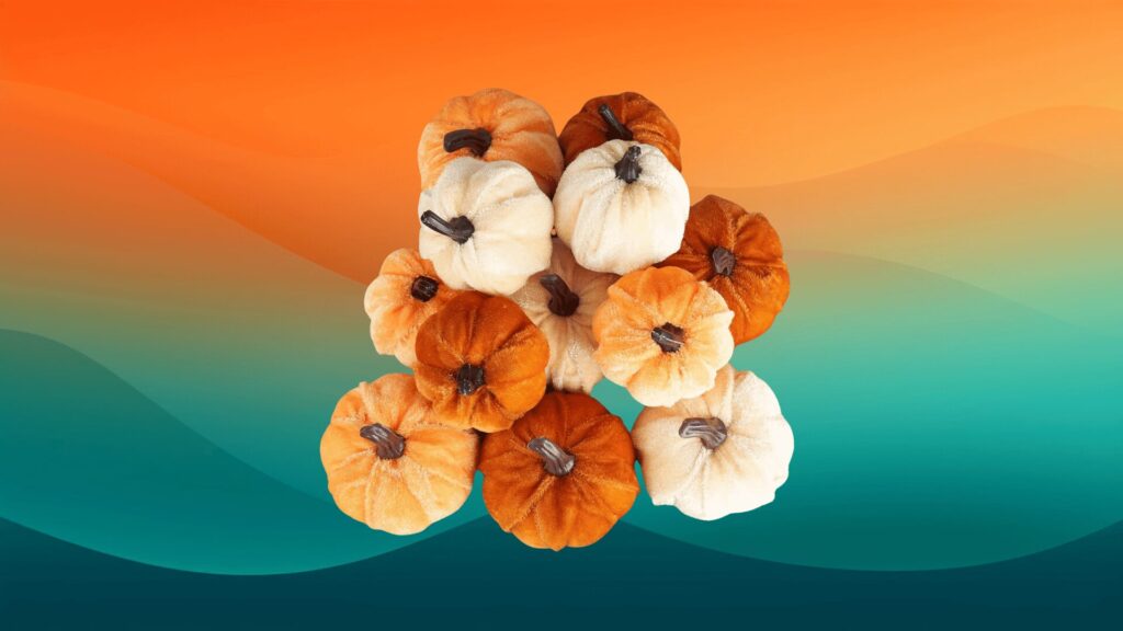 felt orange and yellow pumpkins in front of an orange and teal background