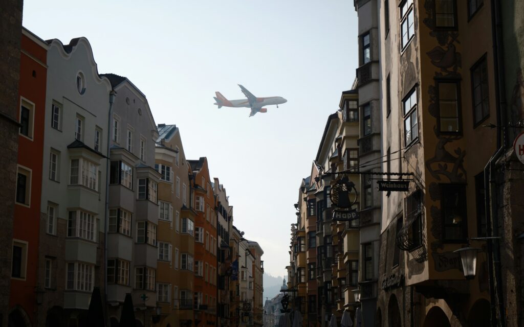 Airplane flying over city neighborhood