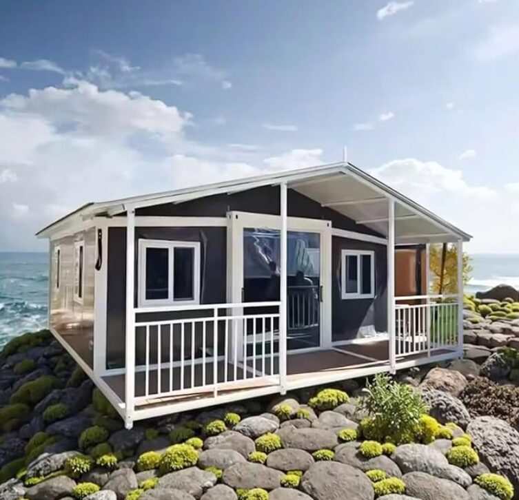 small house on rocks in front of an ocean