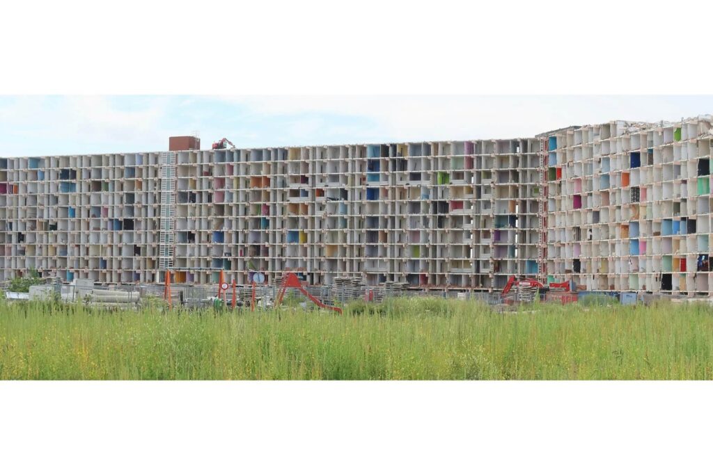 A panoramic view of an apartment complex being deconstructed.