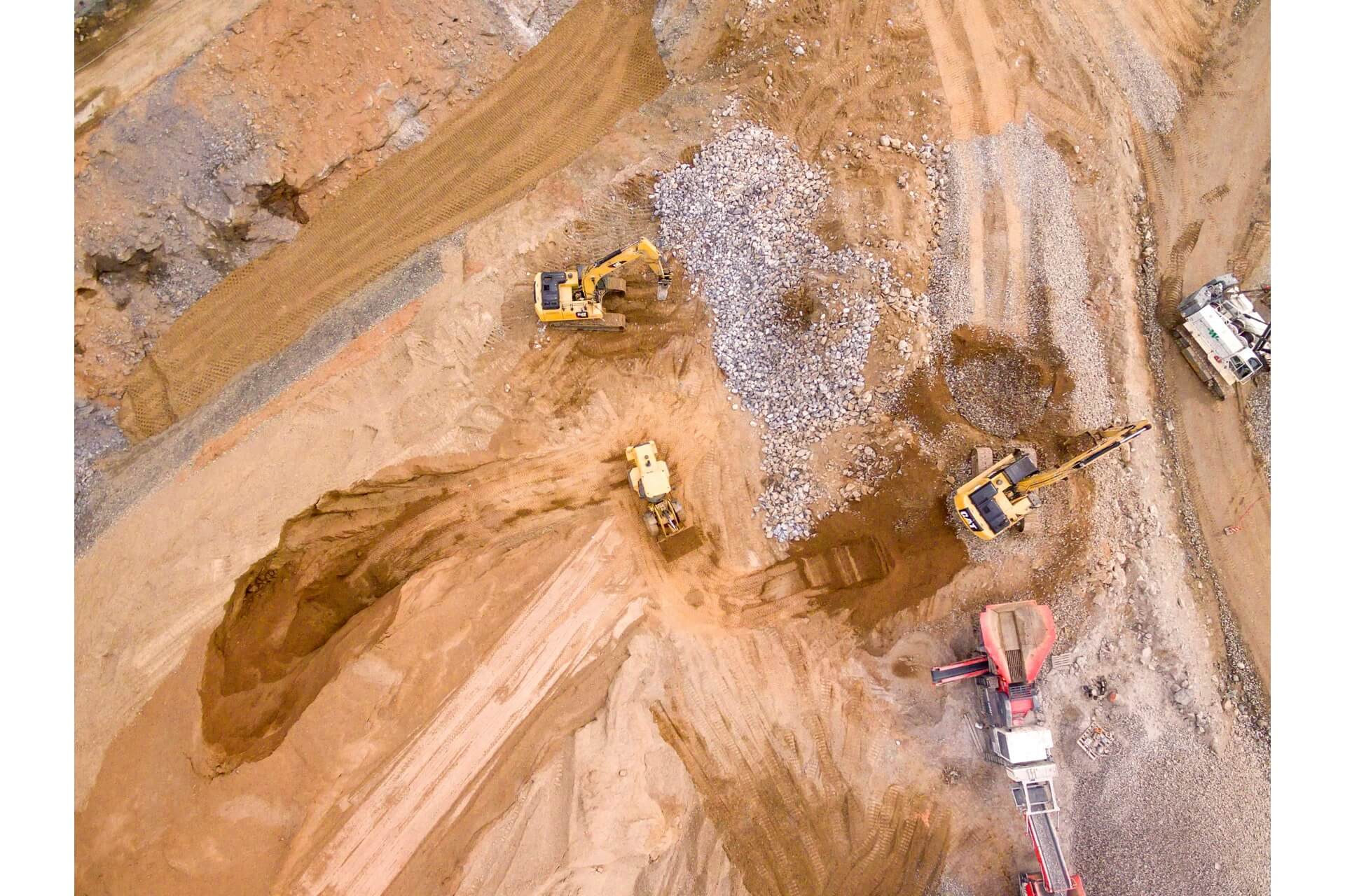 An aerial shot of earthmovers in operation.