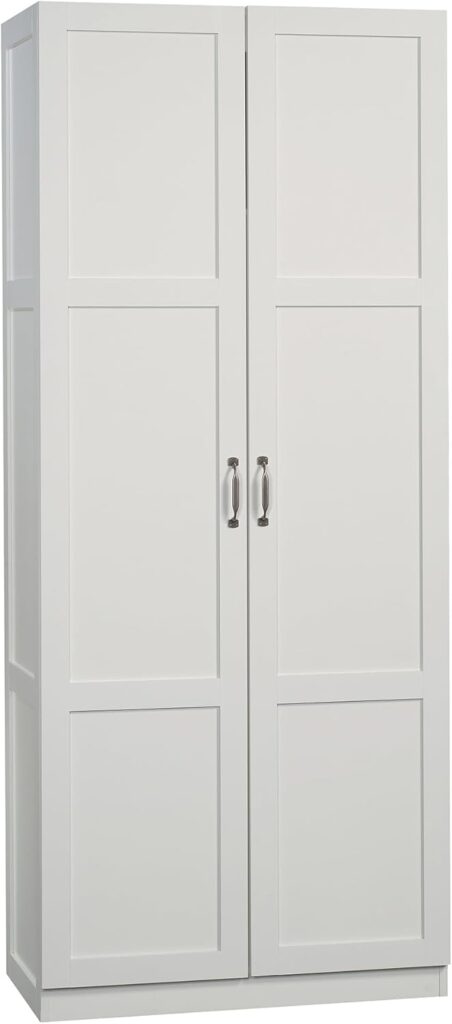 A white storage closet sits against a white background. It has two doors that span the entire height of the unit.
