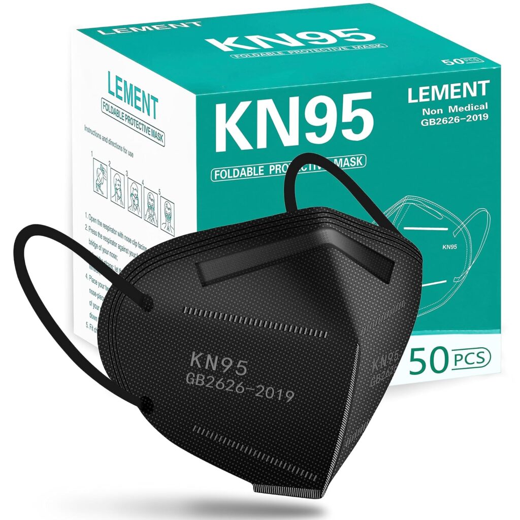 A black KN95 mask sits against the white and teal box it comes in. The background is white. It's the most important tool to use after learning what kills black mold on wood.