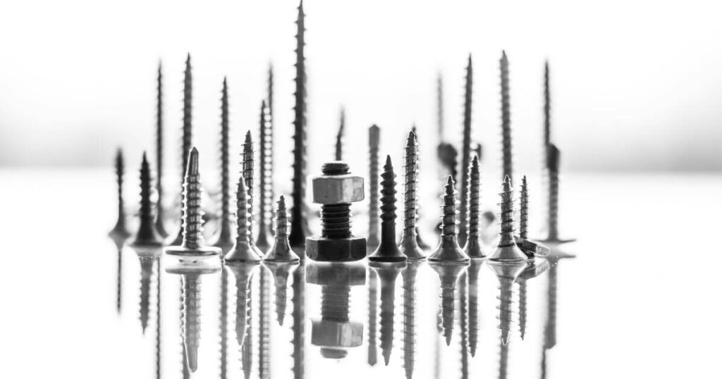 Different types of screws on a white surface.