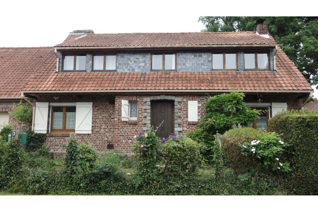 A weathered brick house with clay roof tiles