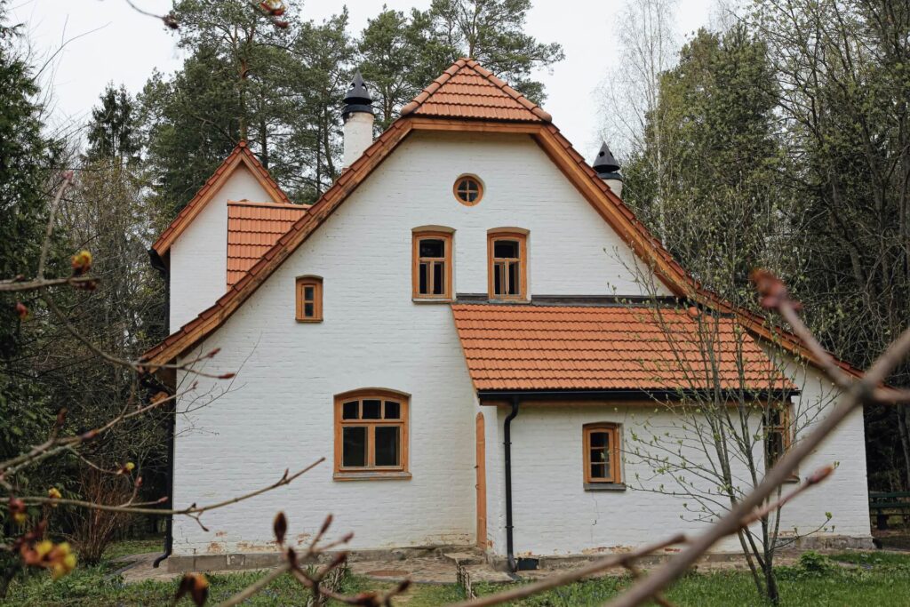 A white brick home with orange clay roof tiles