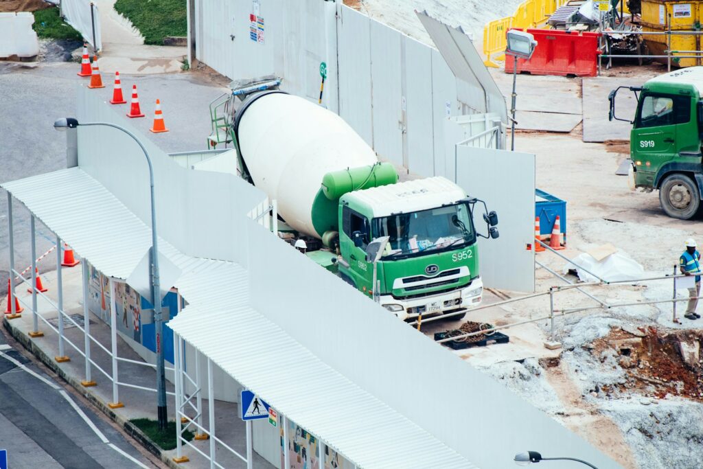 A cement truck at a building site.