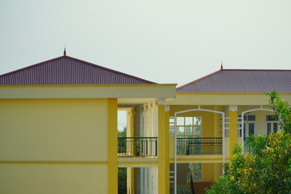 Yellow apartment buildings with red hip roofs