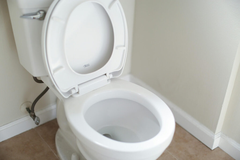 A toilet whose seat is lifted up