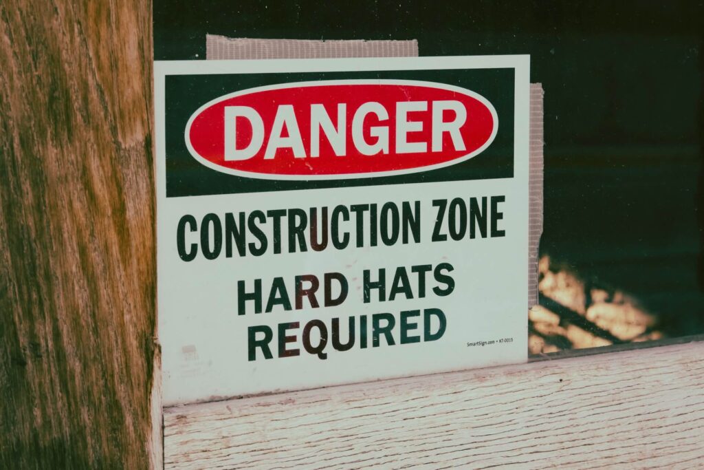 A safety sign reminding people to wear hard hats in the construction zone 