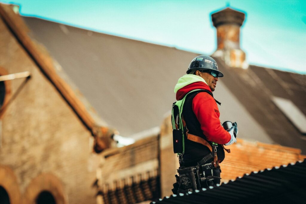 A construction worker wearing personal protective equipment standing outside the job site