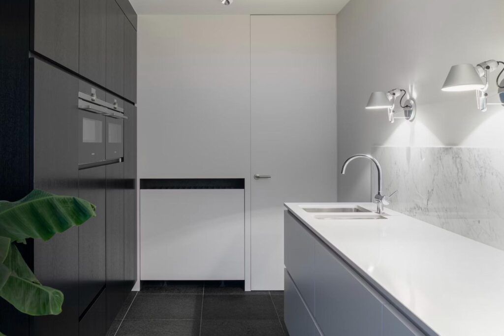 White kitchen with dark cabinets and lighting