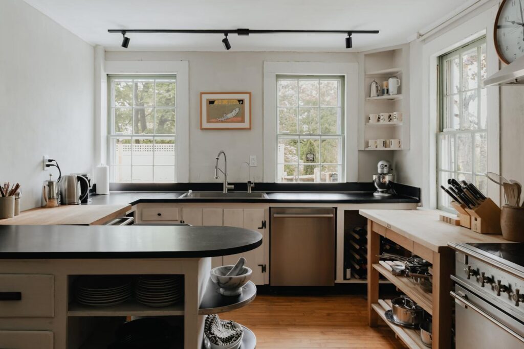 wooden kitchen with counters, stove and  sink