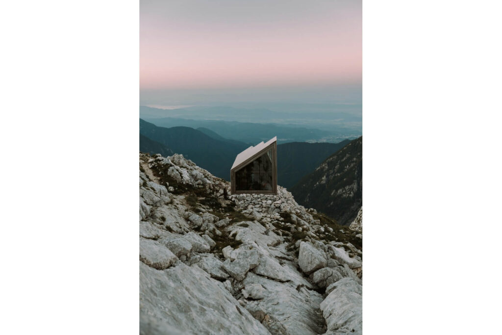 A futuristic house set on a rocky outcrop.