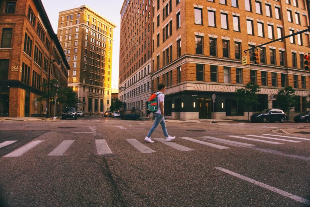 A person crossing a street in downtown Grand Rapids, Michigan