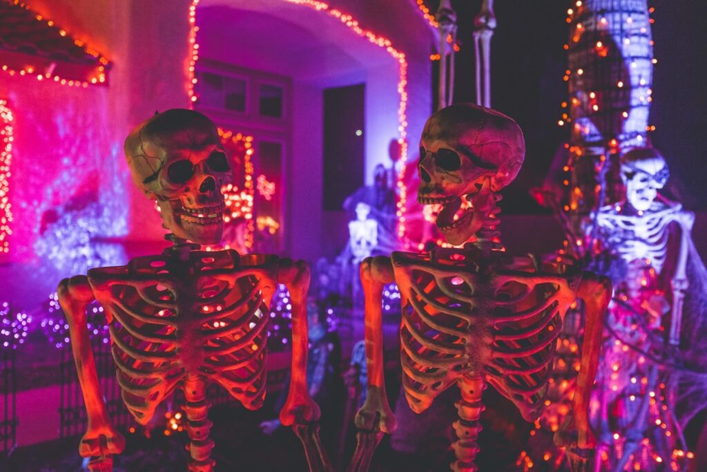 Two skeletons in the foreground of a party image