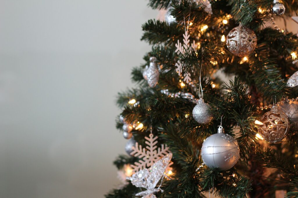 Neutral color ornaments and white lights on Christmas tree