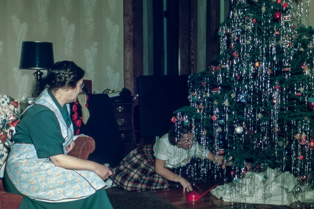 Older woman and child decorating christmas tree