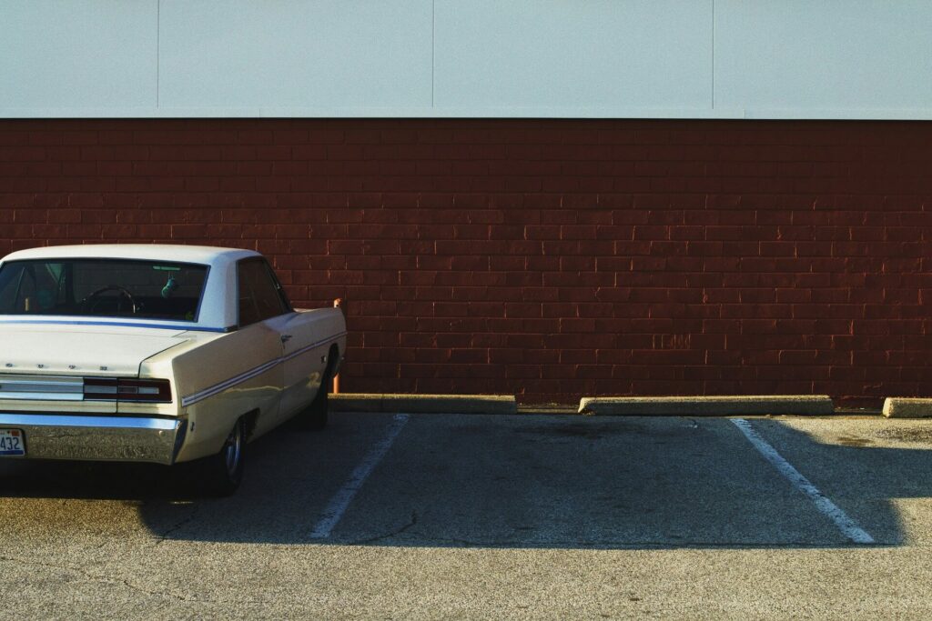 A car parked next to an empty parking space