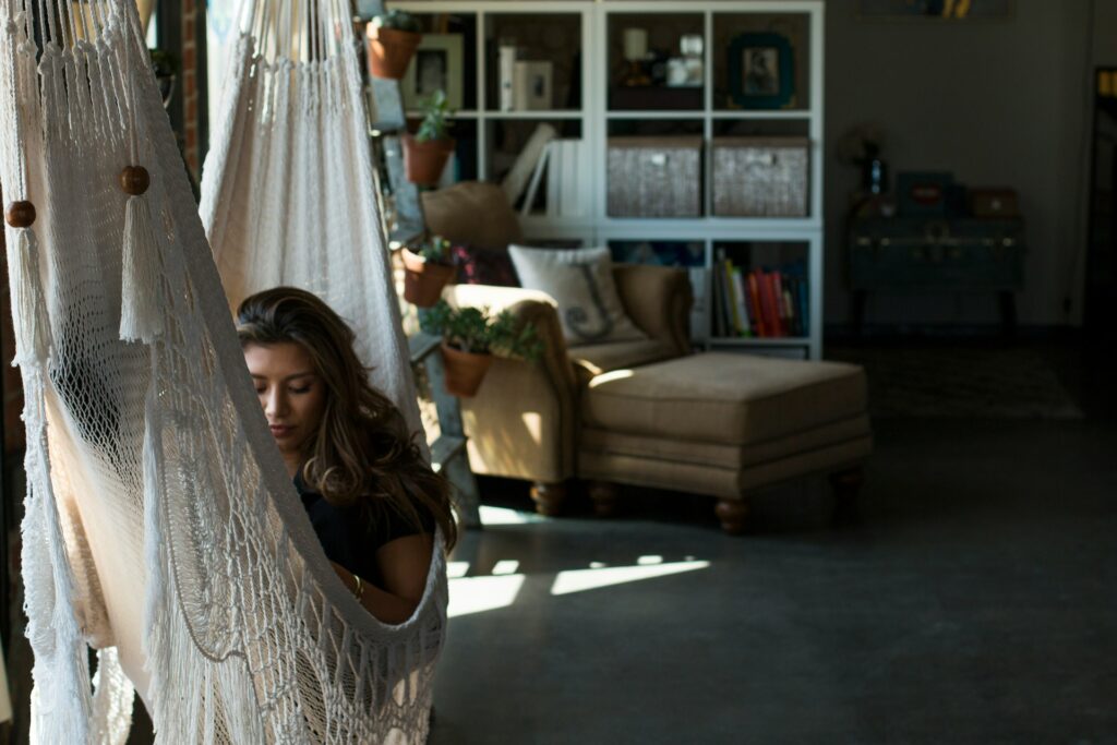 woman reading on a hammock in her home
